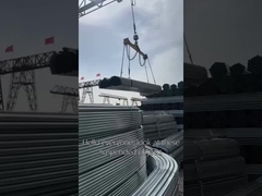 Galvanized steel pipes being transported under sunlight